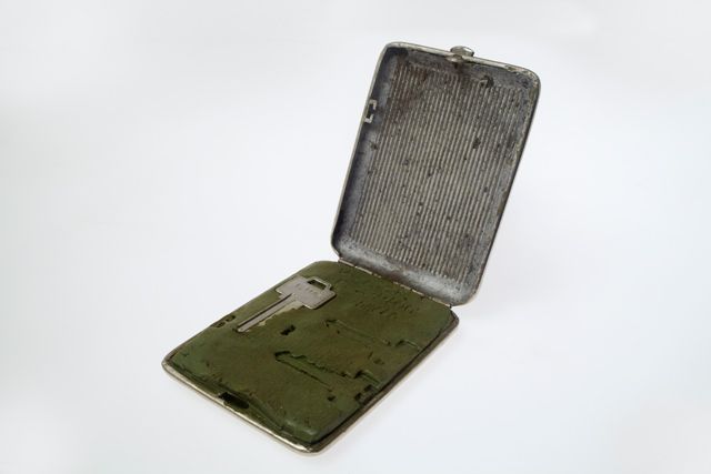 MI6 Key Impression kit inside a Soviet Cigarette case: Picking a lock is the last choice for an intelligence officer when making a covert entry. More preferable, is to obtain, even for a few seconds, the original key and make an impression of it. In this artifact from the 1950s-60s, MI-6 has placed modeling putty inside a conventional Soviet cigarette case to be carried in his pocket without attracting attention. When the officer (or agent) had access to the target key they would simply open the case and press the key into it. Later it would mold a temporary key that would fit into the key cutting kit to produce a duplicate key.